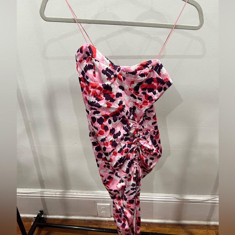 Asymmetrical pink patterned spaghetti strap dress with a side split